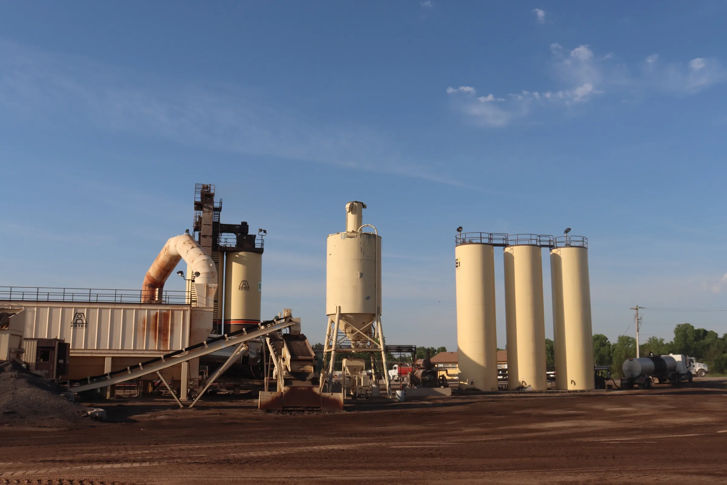 Wide view of the Trinitas Materials plant: drum, conveyors, and silos